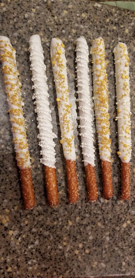 Gold And White Pretzel Rods, Pretzel Rods Dipped Wedding, Gold Party Appetizers, Engagement Party Treats Sweet Tables, New Years Pretzel Rods, Yellow And Gold Birthday Party Ideas, Engagement Party Chocolate Covered Pretzels, White And Gold Chocolate Covered Oreos, Golden Birthday Appetizers