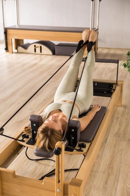 Photo woman training pilates on the refo... | Premium Photo #Freepik #photo #pilates-reformer #yoga-studio #reformer #pilates Pilates Story Instagram, Poses Pilates Foto, Reformer Pilates Exercises, Pilates Reformer Aesthetic, Pilates Pictures, Pilates Reformer Studio, Sofa Poses, Reformer Pilates Aesthetic, Pilates Photos