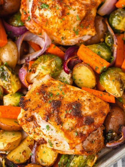 Whip up this Chicken Thigh Tray Bake for a fuss-free meal that's loaded with flavor! With juicy chicken thighs, colorful veggies and a sprinkling of seasonings, everything roasts on one sheet pan for maximum flavor and easy cleanup! Chicken Thigh Traybake Recipes, Chicken Tray Bake Recipes, Juicy Chicken Thighs, Chicken Tray Bake, Sheet Pan Meals Chicken, Colorful Veggies, Sheet Pan Dinners Chicken, Cubed Sweet Potatoes, Sheet Pan Dinners Recipes