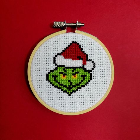 "**This is a downloadable PDF pattern. No physical item will be sent** Name of piece: Santa Grinch Stitch count: 518 Finished size: 1.9 inches x 2.3 inches - Fits in 3\" hoop Thread: DMC - 6 colours Download includes: - Colour symbol chart - List of DMC thread colours and approximate amounts of thread used Due to their nature as digital files, PDF patterns cannot be returned. If you are having any issues, please send me a message. Patterns are for personal use only How to access your digital download: After the payment is successfully processed, you will receive an automatic email notification that the file is ready on the Downloads page. If you have trouble, go back to your account under purchases and you can download the file from there. You will need Adobe Acrobat Reader or another comp Christmas Cross Stitch Patterns Free Ornaments, Cute Cross Stitch Patterns Free, Cross Stitch Grinch Patterns, Grinch Cross Stitch Pattern Free, Plastic Canvas Grinch Ornaments, The Grinch Embroidery, Christmas Cross Stitch Charts, Grinch Cross Stitch Pattern, Small Christmas Cross Stitch Patterns