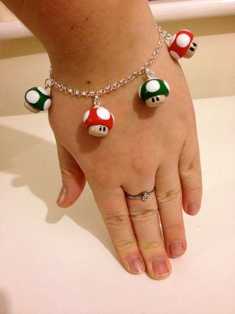 Mario Mushroom polymer clay Charm bracelet in red and green Mario Clay, Clay Charm Bracelet, Polymer Clay Charm Bracelet, Mushroom Polymer Clay, Children Crafts, Clay Inspiration, Business Minded, Clay Figurine, Polymer Jewelry