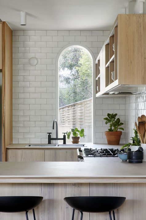 Family-friendly courtyard kitchen in Hampton, Australia with arched window, subway tile walls, and eco-friendly porcelain countertops,. #remodelista #kitchen #interiordesign #remodel Courtyard Kitchen, Therapy Decor, Fixtures Kitchen, Hampton House, Brown Cabinets, White Backsplash, Inspiration Kitchen, House Deck, Remodel Bathroom