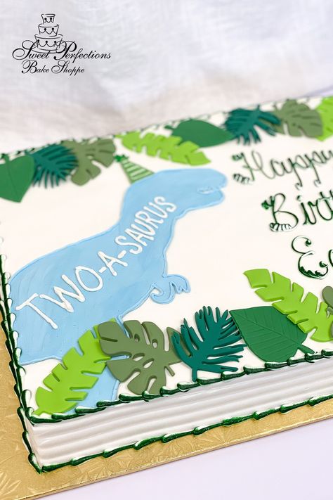 This sheet cake is decorated with a blue buttercream silhouette drawing of a tyrannosaurus-rex (t-rex) with a green party hat. Fondant leaves in a variety of shapes and colors frame the cake on the top and the bottom. Save this dino-mite idea to celebrate your own dinosaur-loving birthday boy! Bonus: this is also a great design for a three-rex or dino-four themed party! #spbakeshoppe Round Dinosaur Cake, Two Rex Birthday Cake, Dinosaur Theme Birthday Cake, Dinosaur 2nd Birthday Cake, Oneasaurus Birthday Cake, Dino Sheet Cake, Dinosaur Sheet Cake Ideas, Easy Dino Cake, Three Rex Birthday Party Boy Cake