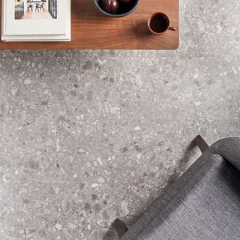 The Rizo LVT Earth 12x24 Glue Down Luxury Vinyl Tile allows you to enjoy a realistic terrazzo look inspired by taupe and gray Italian Ceppo di Gré stone. With Glue Down installation, this LVT can handle serious foot traffic. Unlike traditional terrazzo, this LVT can be installed in a fraction of the time and costs a fraction of the price. The Rizo LVT collection allows you to capture the look of large-format artisanal terrazzo tile in four earth-toned colorways. This collection can be installed Grey Tile Flooring Living Room, Basement Floor Tile, Interior Flooring, Modern Lvt Flooring, Stone Look Vinyl Flooring Kitchen, Lvt Flooring Kitchen, Indoor Concrete Floor Ideas, Stone Look Lvt Flooring, Lvt Flooring Bathroom