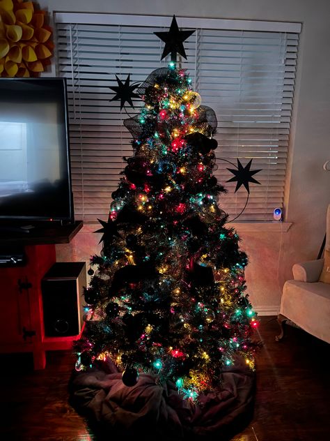 Black Christmas Tree With Colorful Decorations, Black Christmas Tree Colorful Ornaments, Colored Lights Tree, Christmas Tree Colored Lights, Christmas Tree With Coloured Lights, Colorful Christmas Tree Lights Aesthetic, Multi Colored Lighted Trees, Tree With Multi Colored Lights, Colored Christmas Lights