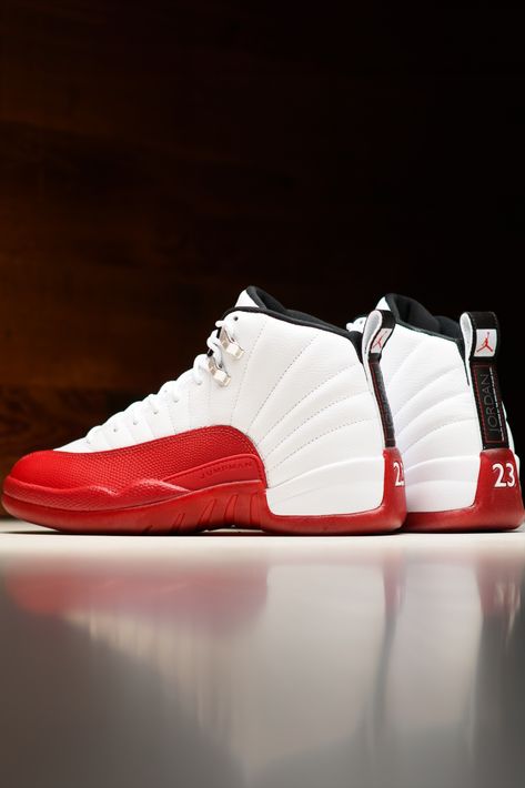 2023's edition of the legendary Air Jordan 12 'Cherry' marks the triumphant revival of the iconic, fan-favorite color scheme. A predominantly white canvas serves as the upper's backdrop with contrasting red making a striking appearance on the textured mudguard. Black accents gracefully adorn the heel tab, lining, and the Jumpman logo on the tongue, while silver eyelets add a touch of elegance around the collar. Jordan 12 White, Jordan 12 Shoes, Jordan 12 Cherry, Red And White Jordans, Jordans Sneakers Outfit, Healing Spell, Jordan 12s, Urban Street Fashion, Jordan Retro 12