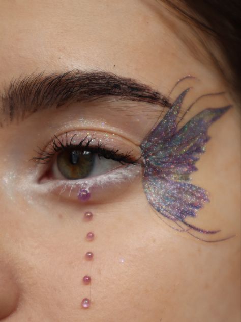 Glittery dreamy butterfly fairy wing eye makeup look Fairy Make Up Look Simple, Fairy Wings Eye Makeup, Fairy Eye Makeup Glitter, Butterfly Sticker Makeup, Fairy Wing Eye Makeup, Fairy Butterfly Makeup, Butterfly Wing Eye Makeup, Butterfly Temporary Tattoo Eye Makeup, Butterfly Wings Makeup