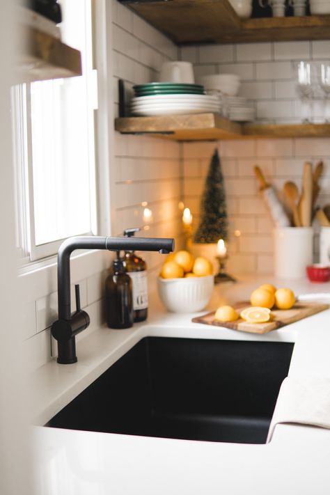 Simple touches like green and white flatware and a small evergreen tree lets this black sink and faucet combo take the stage. Photo by Melissa LeDuc for Dusty Rose. | BLANCO DIAMOND Super Single sink in Anthracite and Posh faucet in Matte Black | Best Kitchen Faucet | Kitchen Sinks and Faucets | Sink Faucet | Faucet Ideas | Industrial Faucet | Black Kitchen Faucet | Kitchen Faucet | Kitchen Faucet Ideas | Black Faucet | Sink Makeover | Sink Decor | Kitchen Sink | Undermount Sink | Holiday Decor Black Sink Hardware Kitchen, Kitchen Sinks Undermount, Modern Sink Faucet Kitchen, Matte Black Sink Kitchen, Blanco Black Kitchen Sink, Kitchen Black Sink And Faucet, Black Kitchen Sinks And Faucets, Black Sink White Kitchen, Black Sink Golden Faucet Kitchen