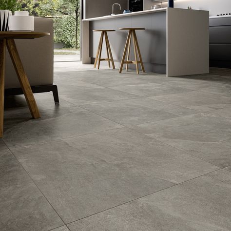 With their neutral tones and natural texture, these Italian tiles marry the authentic beauty of slate with the practicality of porcelain.  Thanks to their warm grey shading and rectified edges, they’ll work in almost any setting, be it a rustic hallway floor or a contemporary family bathroom - their R10 slip rating adds peace of mind underfoot.  That said, we think Midlake Grey looks especially great over a larger floor, such as a kitchen-diner or open plan extension, providing a timeless backdr Grey Tiles Living Room, Gray Porcelain Tile Floor, Grey Kitchen Tiles, Porcelain Superstore, Rustic Hallway, Marble Effect Tiles, Grey Kitchen Floor, Tiles Living Room, Gray Porcelain Tile