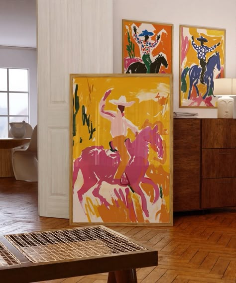 Add a touch of Southwestern flair to your home with this set of 3 vibrant cowboy prints. Each print features a dynamic cowboy scene, rendered in bold, eye-catching colors that capture the spirit of the rodeo. Perfect for adding a pop of color to your living room, office, or bedroom, these prints make a great gift for lovers of Western art and culture. High-resolution digital download Printable in multiple sizes to fit your space Instant download, no physical product will be shipped Unique and co Art Print Living Room, Unique Painting Styles, Interior Design Paintings Wall Art, Modern Western Wall Art, Artful Eclectic Living Room, Funky Colorful Art, Colorful Game Room, Abstract Western Art, Paints For Bedroom Walls