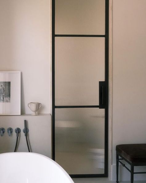 Montana Burnett on Instagram: "Through the looking (fluted ribbed) glass" Ribbed Glass Door Bathroom, Reeded Glass Bathroom, Fluted Glass Bathroom Door, Black Ribbed Glass Door, Fluted Glass Arch Door, Fluted Glass Shower Screen Door, Door Bathroom, Reeded Glass, Glass Doors Interior