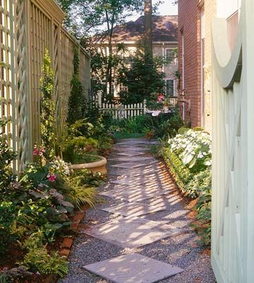 Narrow spaces are popular places to add designed walkways. Here, two sizes of square precast concrete stepping-stones are set on the diagonal to form the base of a corridor through a side yard. Brick edging holds the gravel surrounding the squares in place. Narrow Walkway, Garden Path Ideas, Backyard Ideas For Small Yards, Narrow Garden, Side Yard Landscaping, Walkways Paths, Path Ideas, Side Yards, Garden Walkway