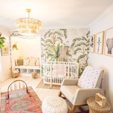 a bright tropical nursery with a tropical printed wall, a tassel chandelier, boho rugs, a leather ottoman and printed pillows Nursery Ideas Tropical, Tropical Rainforest Nursery, Tropical Themed Nursery, Jungle Nursery Girl, Boho Jungle Nursery, Island Nursery, Tropical Nursery, Girl Nursery Room, Jungle Nursery