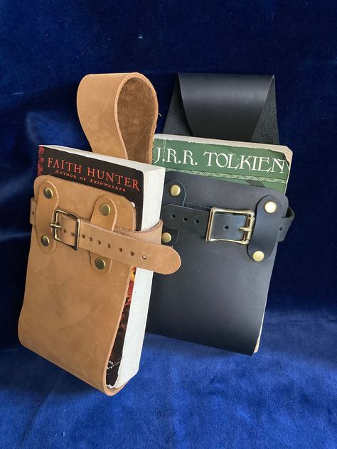 Book Holster for wearing book on belt, made of genuine leather scraps, leather belt holder for book. Renfaire, Cosplay, Renaissance faire Renfest, adjustable from standard paperback to trade (taller) paperbacks. (belt not included) ** for larger books see the listing link at the bottom of this Fits standard paper back books up to 9 inches tall And 16 inches in circumference. (Regular paperbacks and trade (taller) paperbacks , even the thick ones. I make these out of scraps from my leather straps Book Holster, Holster Belt, Leather Book Covers, Leather Scrap, Ren Fair, Fest Outfits, Belt Holder, Leather Scraps, Book Holder