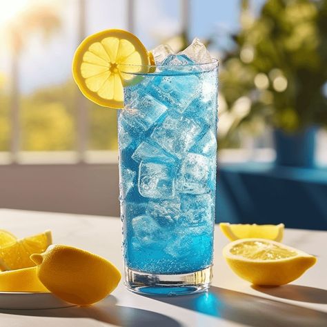 The Blue Lagoon Mocktail has a refreshing, sweet, and slightly tangy taste. The combination of lemonade, blue curaçao syrup, and lime juice creates a perfect balance of flavors, making it a light and enjoyable drink. Blue Mocktail, Blue Lemonade, Blue Lemonade Aesthetic, Blue Lemonade Cocktail, Blue Lemonade Recipe, Blue Mock Tail, Blue Lagoon Drink Non Alcoholic, Blue Lagoon Drink, Curacao Drink