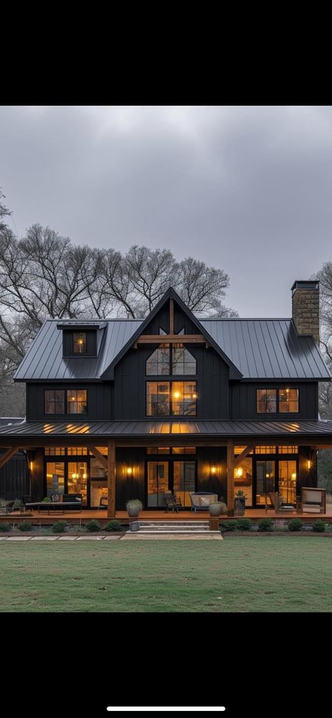 Black Barnhouse Homes, Black And Dark Wood House Exterior, Dark Metal House, Modern Rustic Home Design Exterior, Black Tin House Exterior, Black House Wrap Around Porch, Dark Farmhouse Exterior Wrap Around Porch, Modern Black House Design, Barndominium Dark Exterior