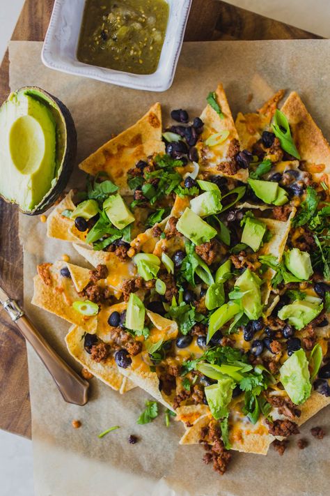 Looking for easy grain free dinners? These sheet pan beef nachos are so simple and so delicious! You only need a few ingredients like grassfed ground beef, black beans, Siete tortilla chips, avocado, cilantro and grated cheese for this easy grain free dinner. Click through for how to make these clean eating healthy nachos. #healthynachos #cleaneating #grainfree #grassfedbeef Grain Free Dinners, Sheet Pan Nachos Recipe, Sheet Pan Beef, Grain Free Dinner, Sheet Pan Nachos, Healthy Nachos, Pan Nachos, Beef Nachos, Nachos Recipe Easy