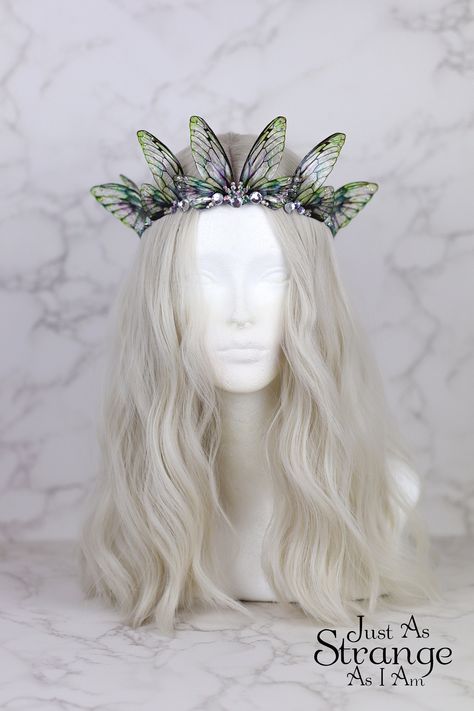 This is a must-have for all fairies! Here we have a beautiful tiara, fit for any fairy queen! This enchanting crown is comprised entirely of my handmade bright green fairy wings. The wings are attached a metal silver band, and adorned with clear gemstones. The wings are lightweight and far more durable than their glassy appearance might suggest! One size ought to fit all, but do message me if you are unsure. This tiara is best suited to adults over children, due to small parts. This is definitely a head turner! This beautiful crown is absolutely perfect for any fairy costumes and cosplays, Pagan or Wiccan events, weddings, proms - or even everyday wear. This would make the perfect addition to your festival outfit, bridal attire, renaissance costume ... the possibilities are truly endless. Green Fairy Wings, Faerie Costume, Clear Gemstones, Festival Crown, Fairy Headpiece, Fairy Costumes, Fairy Crown, Fairy Festival, Bridal Attire