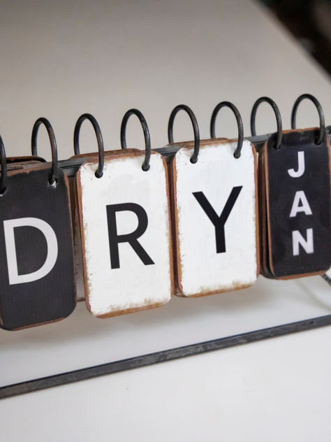 A sign sitting on a desk that says "DRY Jan". Dry January Aesthetic, Making Healthy Choices, Dry January, Healthier Eating, January 2025, January 3, A Glass Of Wine, Glass Of Wine, 2025 Vision