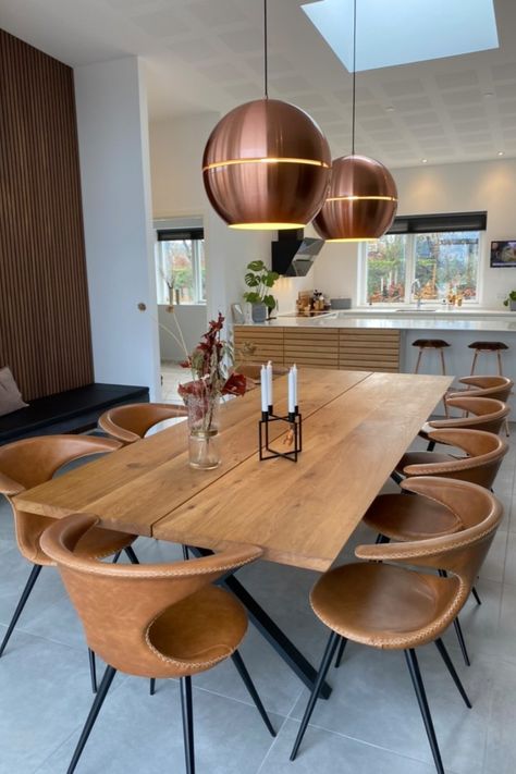 9 of DAN-FORM's FLAIR chairs in light brown leather around a wood table, in a kitchen/dining room with vaulted ceilings, copper pendants and modern decor. Tan Chairs Dining Table, On Trend Dining Chairs, Leather Chair Dining Table, Leather Kitchen Chairs With Table, Dining Table With Leather Chairs, Brown Leather Kitchen Chairs, Brown Chairs Dining, Wood Dining Table With Brown Leather Chairs, Leather Chairs Dining Table