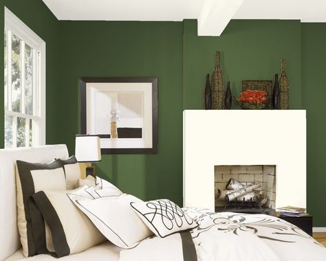 The deep yet tranquil tones of Benjamin Moore's Colonial Verdigris CW-530 creates a soothing atmosphere in this bedroom. The subtle warmth of Simply White OC-117 on trim, ceiling, and fireplace complements the decor and rich green. #benjaminmoore #greenpaintcolor #paintinspiration Colonial Verdigris, Best Bedroom Paint Colors, Sophisticated Bedroom, Hale Navy, Living Room Red, Relaxing Bedroom, Yellow Bedroom, Bedroom Paint Colors, Trendy Bedroom