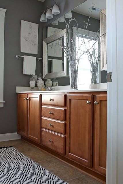 Grey walls – Sherwin Williams “Gray Shingle”- also, the frames on top of the mirror @ DIY Home Gray Bathroom Walls, Bathroom Wall Colors, Honey Oak Cabinets, Brown Cabinets, Oak Kitchen Cabinets, Bathroom Paint Colors, Kitchen Paint Colors, Oak Kitchen, Trendy Bathroom