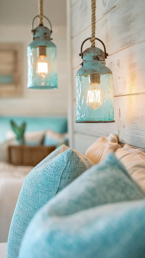 The right lighting can shift a coastal bedroom from ordinary to breathtaking. Carefully chosen coastal bedroom lighting creates a soft, breezy atmosphere that captures the essence of relaxed seaside living. Woven rattan pendants, driftwood table lamps, and glass sconces with a candlelit glow all work together to reflect the ocean’s calm energy. Layering warm LED bulbs with natural textures and reflective surfaces enhances the airy, tranquil feel that defines coastal interiors. Coastal Bedroom Lighting, Nautical Pendant Lighting, Seashell Chandelier, Marine Life Art, Coastal Bedroom Ideas, White Washed Furniture, Bedroom Decorating Tips, Calm Energy, Pebble Floor