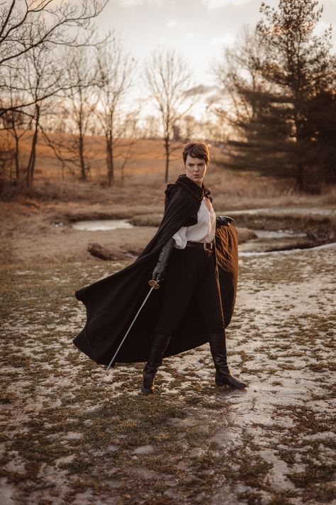 "Join the FOTW Realm and get an instant 10% off code! http://eepurl.com/hrobtv Give your costume flair with one of our linen hooded Ranger cloaks! These full flowing long capes are made with high quality 100% linen - giving them a very historical look & feel. Features a large pointy hood, full draping curved shoulders & a strong adjustable leather tie at the neck. ~ Adult one-size-fits all ~ Length approx. 50\" Credit: picture #1-2 by @theladynerd& @lizabetroberts, picture 3 by @theswordandthese Cloak Blowing In The Wind, Duo With Swords Pose, Person Wearing Cloak, Flowing Cape Drawing Reference, Cape Pose Reference, Cloak Poses, Cloak Photoshoot, Medieval Traveler, Cloak Aesthetic