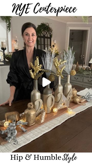 Deborah Bitton on Instagram: "Sharing a super simple centerpiece idea for your NYE celebration…  I spray painted 4 wine bottles with gold metallic paint and glued on some wood numbers. Then popped in some picks from the party section at @hobbylobby. I filled in the space with glitter ribbon and lights and added some gold Christmas bells to “ring in the New Year!  Super festive and simple for any space in your house…  Last week of the year, who’s ready for it?!! I am so ready to be done with this year 👊🏻 • • • #newyearsdecor #centerpeices #newyearsparty #newyearseveparty #diycenterpieces New Years Eve decorations" Gold Christmas Bells, Wood Numbers, Nye Celebration, Simple Centerpiece, Wine Bottle Centerpieces, Simple Centerpieces, Glitter Ribbon, New Years Eve Decorations, Diy Centerpieces