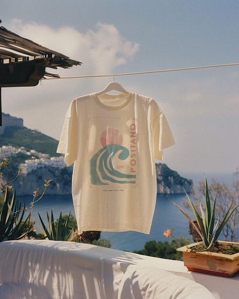 Seize the surf in our Positano 1980 Tee. For the girl who makes waves both on the beach and off, this is your summer statement tee. Unisex soft cotton crew neck t-shirt featuring a Positano Italy Surf Camp graphic printed on the front. Fabrics: 100% cotton, 6 oz Made in: LA Surf Brands Clothing, Beach Graphic Tee, Surf Merch, Summer Graphic Tees, Beach Shirt Design, Surf Baby, Surf Fashion, Beach Tshirt, Surf Aesthetic