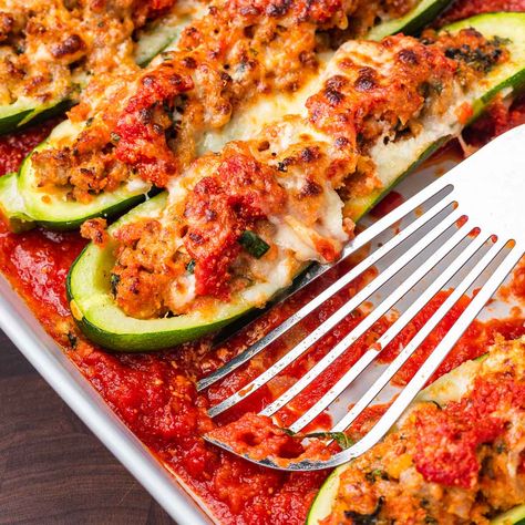 Zucchini boats stuffed with sausage, breadcrumbs, onion, cheese, and garlic, topped with marinara and mozzarella, and baked until bubbly. Sausage Stuffed Zucchini Boats, Zucchini Boats Recipe, Sip And Feast, Zucchini Boat Recipes, Sausage Marinara, Veggie Side Dish Recipes, Stuffed Zucchini Boats, Yellow Squash Recipes, Sausage Stuffed Zucchini