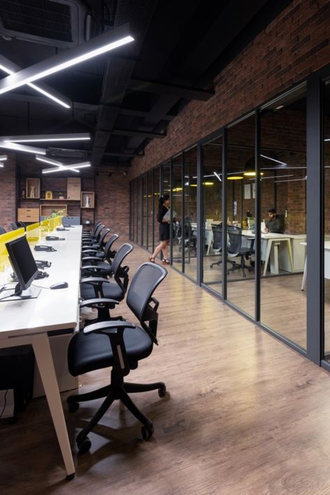 Even the stereotypically functional open office has been treated with a statement ceiling design that gives the space character and the colour ‘yellow’ that creates interest in the working surfaces. Exposed Ceiling Office, Modern Industrial Office Space, Exposed Ceiling Design, Workspace Design Office, Modern Industrial Office, Ceiling Office, Statement Ceiling, Industrial Office Space, Exposed Ceiling