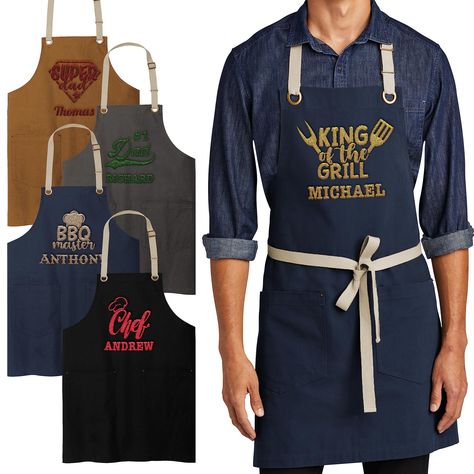 PRICES MAY VARY. Personalized Embroidery: Our customizable embroidered apron allows customers to add a personal touch with 12 different designs to choose from. Alternatively, they can opt for a text-only option, making it a perfect canvas for custom messages or monograms. Stylish Color and Material Choices: Available in four stylish color options - duck brown, river navy blue, magnet, and black - our aprons are made from 100% cotton canvas. This ensures durability and a comfortable feel while co Customized Aprons, Aprons Design, Customised Aprons, Unique Aprons, Branded Aprons, Apron For Men, Birthday Presents For Dad, Canvas Apron, Embroidered Apron