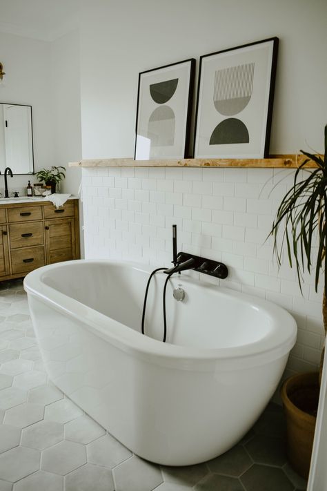 How to Choose the Best Bath Tub for Your Space | House On Longwood Lane -  white subway tile bathroom, picture ledge bathroom, american standard cadet tub, matte black bathroom hardware, eclectic bathroom, diy bathroom remodel, wooden bathroom vanity, bathroom remodel, white bathroom, white subway tile wall, bathroom plants, behr polar bear, modern block prints, hexagon tiles, cement tiles, modern farmhouse vanity, bathroom shelf styling Modern Eclectic Bathroom, Neutral Bathrooms Designs, Eclectic Bathroom, Wooden Bathroom, White Bath, Subway Tiles, Boho Bathroom, Trendy Bathroom, Bathroom Renos