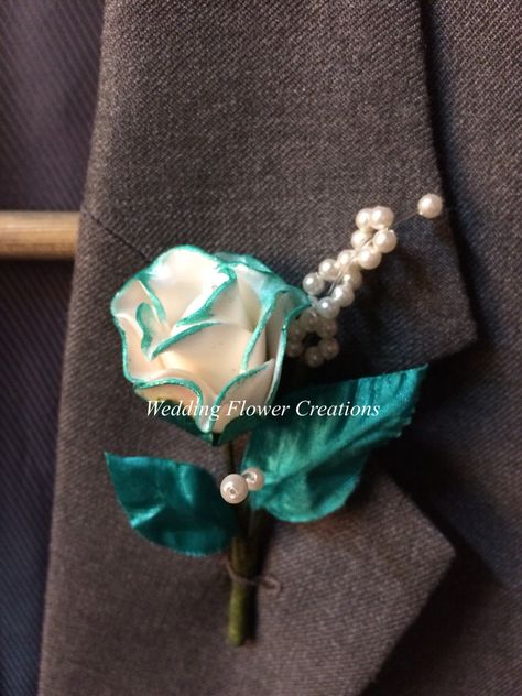 An elegant off white rose with hints of teal Teal Boutonniere, Wedding Entourage, Teal Accents, Flower Corsage, Boutonniere Wedding, Boutonniere, White Rose, White Roses, Wedding Flowers