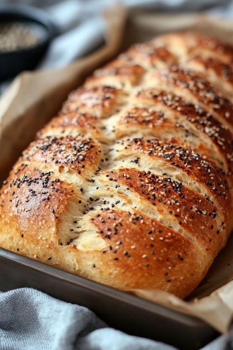 Freshly baked braided bread topped with black and white sesame seeds in a baking tray. Bread Machine Everything Bread, Bread Machine Whole Grain Bread, Fun Bread Machine Recipes, Everything Bread Machine Recipe, Bread Machine Recipes With Regular Flour, Bread Machine Crusty Bread, Bread Oven Recipes, Hitachi Bread Machine Recipes, Simple Bread Machine Recipes