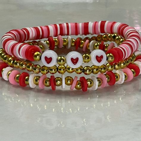 Set of 3 Valentine stretch braceletsFits most wristsPerfect for Valentine's DayIncludes a red and white heart braceleta red and white gold bead braceletand a plain gold bead bracelet. Heart Clay Bead Bracelet, Red And Pink Clay Bead Bracelets, Valentines Bracelets Ideas, Valentine Clay Bracelets, Valentine’s Bracelets, Valentine’s Day Clay Bead Bracelet Ideas, Valentine Beaded Bracelets Diy, Valentines Beaded Bracelet Ideas, Valentine Bracelets Beads