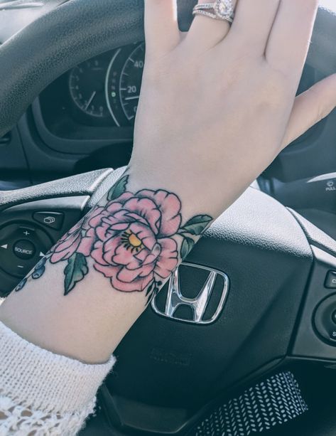 Pink flower with blueberries and green leaves wraparound wrist tattoo Corsage Tattoo Wrist, Color Wrist Tattoo, Wraparound Wrist Tattoo, Wraparound Tattoo, Wrist Tattoo Ideas, Flower Wrist Tattoos, Sleeve Ideas, Sleeves Ideas, Wrist Tattoo