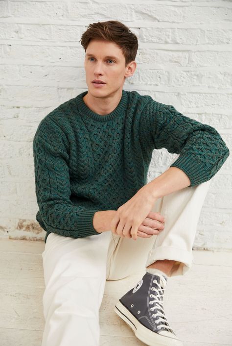 A symbol of Ireland past and present, the Inisheer Traditional Aran Sweater is a timeless addition to your wardrobe. Made with 100% Merino wool, the quality of this authentic Irish gem cannot be rivalled. It is a true Irish hero Aran piece.   Much like its namesake, the Inisheer Aran Sweater captures the essence of Ireland in all of its glory. With a beautiful combination of traditional Aran stitches such as honeycomb, moss and cable, this piece is inspired by the past while remaining firmly roo Irish Outfit Men, Forest Green Outfit Men, Mens Fashion Pastel, Soft Natural Men Kibbe Style, Christmas Outfits Aesthetic Men, Jewel Tone Outfits Men, Green Men Aesthetic, Christmas Sweater Outfit Men, Green Cable Knit Sweater Outfit