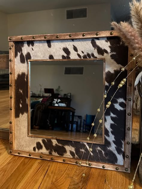 "MIRROR 12\"x12\" Surrounding Framing 20\"x20\"  Want a custom fabric or design? Just ask.  Custom Hand Crafted Wall Mirrors.  Western Cowprint Pattern with Studded Frame. IN CUSTOMIZATION OPTIONS PLEASE SELECT STAIN COLOR.  Hanging hardware included. Real wood and shatter proof mirror.  Available in Stained or Painted. Sizes are approximate between 19-20\"" Diy Decorative Mirror Frames, Country Western House Decor, Cow Print House Decor, Country Western Christmas Decor, Cute Western Decor, Cow Print Headboard, Cow Print Home Decor, Western Theme Room Decorating Ideas, Diy Cowhide Mirror