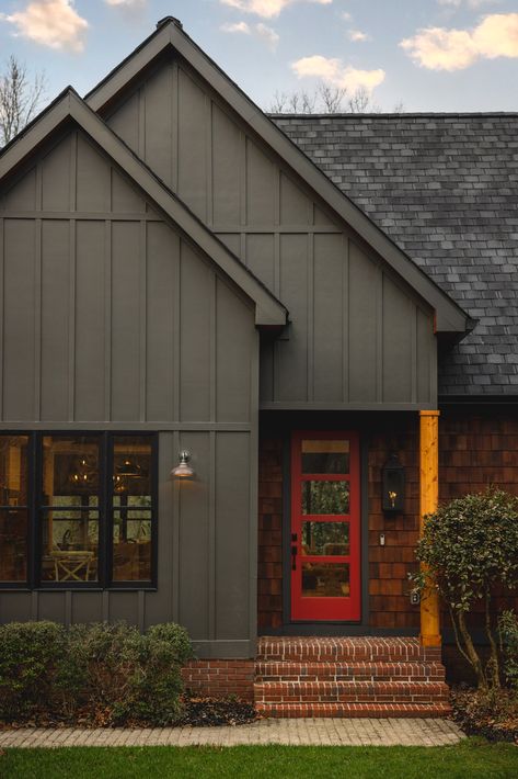 Black House Red Trim, Dark Blue And Red Brick House, House Siding Color Ideas, Dark House Exterior Colors, Green House Red Door, Board And Batten Siding With Brick, Dark Gray House Exterior, Dark Green House Exterior, Cabin Exterior Colors