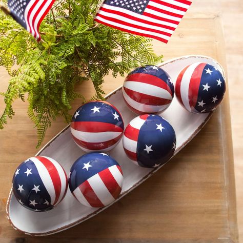 Add a patriotic look to home decor or other decorative pieces with these stars and stripes orbs. A great addition to Fourth of July decorations, these orbs look great in buckets, pails or any other container that needs a boost of patriotism. Display these orbs on the Fourth of July or any other patriotic holiday - or anytime of year when you want to show off your pride in the USA! Foam. (6 pcs. per unit) 3 1/2" diam. Patriotic Decorations Diy, 4th Of July Tiered Tray Decor, Decorative Orbs, Patriotic Tiered Tray Decor, Bucket Decor, Patriotic Decorations Party, Military Christmas, July Desserts, Indoor Holiday Decor