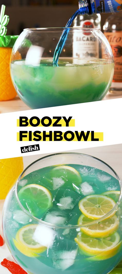 This massive Boozy Fishbowl is big enough for your whole crew. Get the recipe at Delish.com. #alcohol #cocktail #booze #boozy #fishbowl #punch #rum #delish #recipe #easyrecipe #bluecuracao Fishbowl Drink, Easy Party Drinks, Alcoholic Punch Recipes, Rum Punch Recipes, Party Punch Recipes, Alcoholic Punch, Jungle Juice, Liquor Drinks, Rum Punch