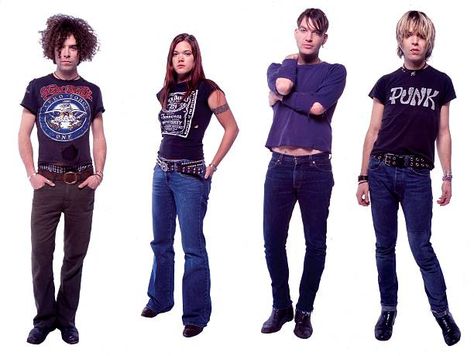 Photo of DANDY WARHOLS and Brent De BOER and Zia McCABE and Courtney TAYLOR-TAYLOR and Peter HOLMSTROM Dandy Warhols, Turquoise Jeans, Group Portrait, Brown Teddy Bear, Light Jeans, Black Aviators, Light Music, Black Leather Belt, Embroidered Jeans