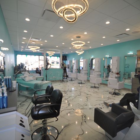 The construction process of this new hair salon started with the removal of the old store. All new plumbing, electric and insulation were installed before new sheet rock and drop ceilings. New ornate lighting system, with high hats and a chandeliers were installed. The walls were painted with a happy blue teal color to create a pleasant atmosphere. The floors were installed with the newest epoxy floor technology, creating a one-piece marble look imitating black veins in a real white marble floor Hair Salon Lighting Ideas Ceilings, Salon Lighting Ideas Ceiling, Salon Chandelier Ideas, Blue Hair Salon, Salon Lighting Ideas, White Hair Salon, Drop Ceilings, Salon Suite Decor, Salon Lighting