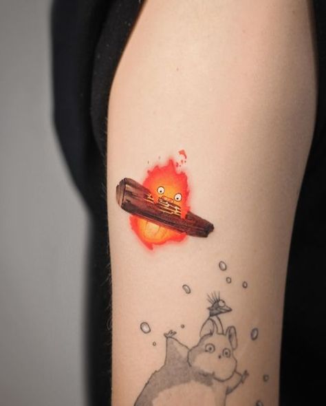 Deborah Genchi on Instagram: "As you loved it… a flaming Calcifer 🔥 becomes part of the collection! 😍 (The other black characters are not from me) @debrartattoos  #debrartist #debrartattoos #calcifer #miyazakitattoo #studioghiblitattoo" Calsifer Howl Tattoo, Studio Ghibli Calcifer Tattoo, Calsipher Tattoo, Howls Moving Castle Tattoo Calcifer, Calcifer Drawing, Studio Ghibli Calcifer, Calcifer Tattoo, Miyazaki Tattoo, Ghibli Tattoos