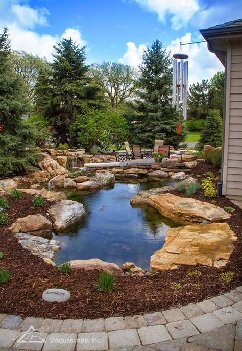 Enjoy your backyard patio with a water feature wrapping around it. #Ponds #GardenPond Rain Garden Design, Garden Design Layout Landscaping, Large Backyard Landscaping, Small Pond, Fountains Backyard, Topiary Garden, Backyard Water Feature, Pond Landscaping, Natural Pond