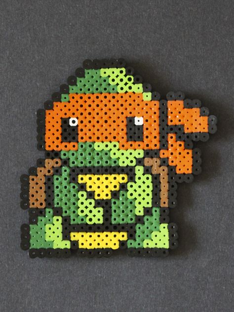 TMNT Baby Michelangelo, perler bead sprite by Kesley Rushing on Etsy | Ninja turtles Perler Bead Ninja Turtle, Perler Bead Sprites, Tmnt Perler Beads, Michelangelo Ninja Turtle, Tmnt Michelangelo, Perler Creations, Pixel Beads, Melty Bead Patterns, 8bit Art