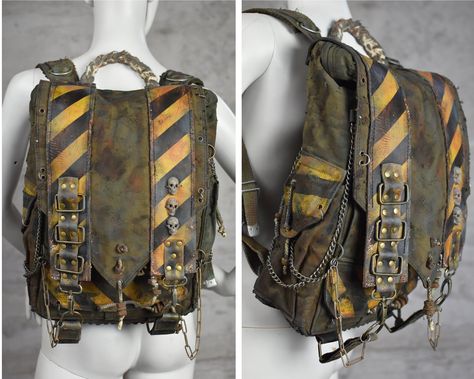 Get ready for the post-apocalyptic world with this military green backpack made from waterproof army canvas.  Adorned with yellow biohazard stripes, skulls, and chains, this backpack is perfect for those with a unique sense of style. It features two side pockets, two pockets under the flap, and a drawstring main compartment. There's also a small zipper pocket at the back for added security. With plenty of attachment points, you can easily carry everything you need for your next adventure. Whethe Dystopian Backpack, Wasteland Outfit Men, Post Apocalyptic Jacket, Unique Fashion Men, Apocalypse Bag, Wasteland Outfit, Post Apocalyptic Accessories, Wasteland Fashion, Wasteland Clothing