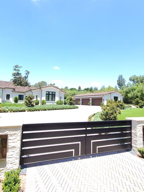 Check Out These Beautiful Garage Doors and a Driveway Gate, installed by Access in 2020!  We design and install every kind of garage door in steel, aluminum, wood, or fiberglass, you name it.  Access would like to thank our customers for giving us an opportunity to make their homes look beautiful. We offer the best designs, quality, service, and automation. We look forward to earning your business.  The Doors You Open Determine the Life You Live Modern Gated Driveway Entrance, Gated Driveway, Beautiful Garage, Entrance Landscaping, Aluminum Driveway Gates, Automatic Gates Driveways, Driveway Entrance Landscaping, Dream Ranch, Modern Driveway